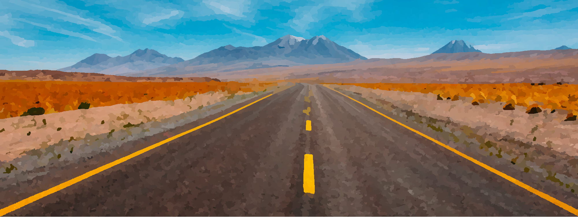A highway with mountains on the horizon.